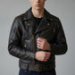 Scarlett Stitch dark brown leather biker jacket with contrast stitching, metal zippers, and waist belt on a model