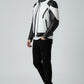Scarlett Stitch men's black and white leather motorcycle jacket with quilted shoulder panels and zippered pockets.