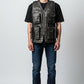 Man wearing a Scarlett Stitch distressed dark brown leather utility vest with multiple pockets over a black t-shirt.