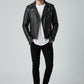 Model wearing a Scarlett Stitch black faux leather biker jacket with asymmetrical zip, belt, and silver hardware.