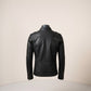 Scarlett Stitch Men's black faux leather moto jacket with zippered cuffs and epaulet details.