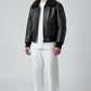 Scarlett Stitch Men's black faux leather bomber jacket with dark brown shearling collar, zip front, and chest pockets.