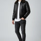Scarlett Stitch Men's black faux leather bomber jacket with dark brown shearling collar, ribbed cuffs and hem, zip front, and flap chest pockets.