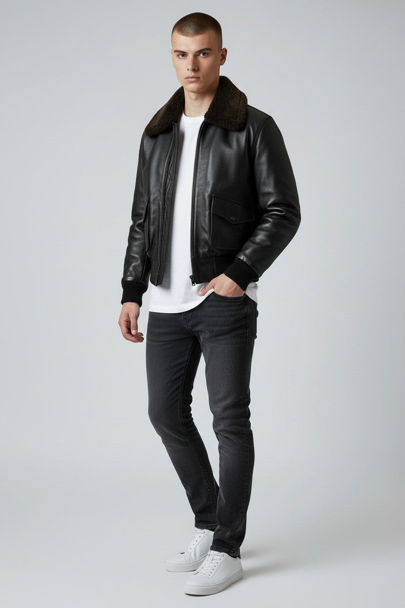 Scarlett Stitch Men's black faux leather bomber jacket with dark brown shearling collar, ribbed cuffs and hem, zip front, and flap chest pockets.