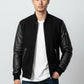 Scarlett Stitch Men's black bomber jacket with genuine leather sleeves, ribbed collar, cuffs, hem, and zippered pockets.
