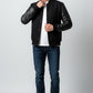 Scarlett Stitch Men's classic black varsity bomber jacket with genuine leather sleeves, snap-button front, and ribbed trim.