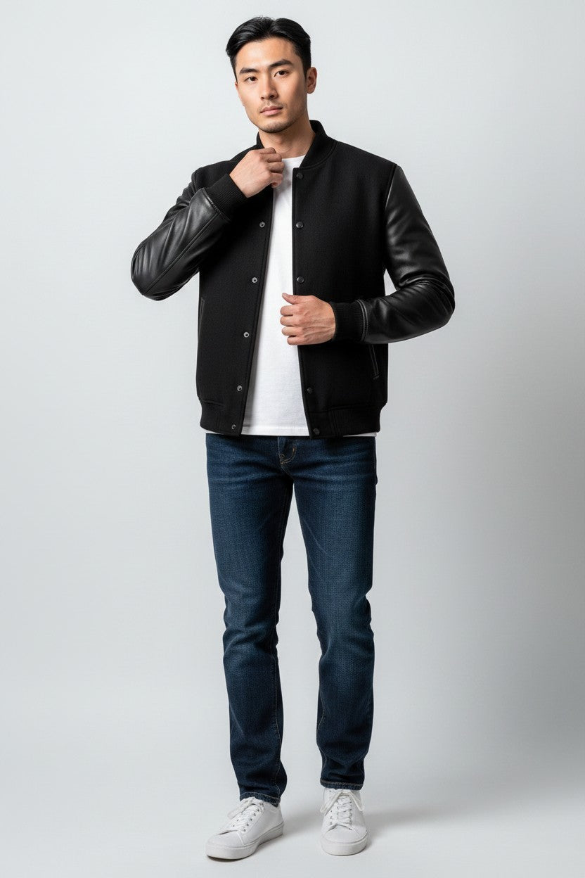 Scarlett Stitch Men's classic black varsity bomber jacket with genuine leather sleeves, snap-button front, and ribbed trim.