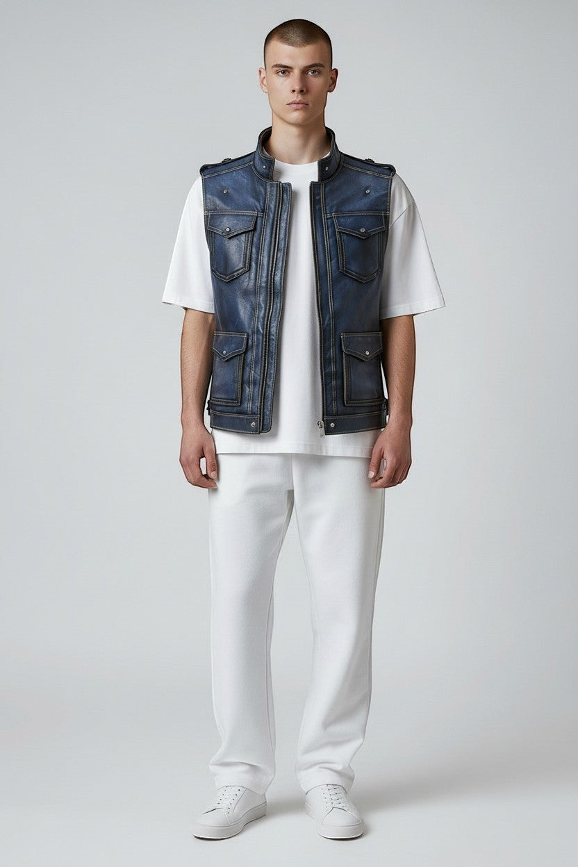 Model wearing a Scarlett Stitch distressed blue leather utility vest with snap pockets over a white t-shirt.