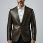 Man wearing a Scarlett Stitch dark brown leather blazer with a white shirt and structured two-button design.
