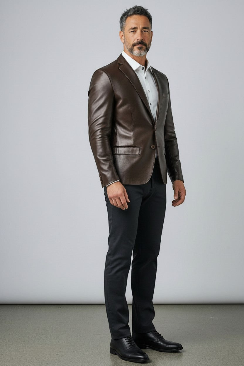 Model wearing a Scarlett Stitch dark brown leather blazer with a white shirt and dark trousers in a studio setting.