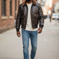 Scarlett Stitch Men's dark brown faux leather bomber jacket with shearling collar, zip-front, flap pockets, ribbed cuffs and hem.
