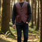 Scarlett Stitch men's burgundy leather vest with lapel collar, button front, flap pockets, and belt detail. Tailored fit.