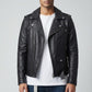 Model wearing a black Scarlett Stitch leather biker jacket with silver hardware, white tee, and blue jeans.