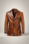 Scarlett Stitch men's genuine leather blazer in warm brown. Features notched lapel, three-button closure, chest pocket, and flap pockets.