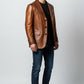 Scarlett Stitch Men's genuine leather blazer jacket in warm brown with notched lapel and three-button closure.
