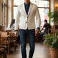Man wearing a Scarlett Stitch off-white leather blazer with a navy shirt and jeans in a cafe setting.