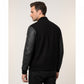 Scarlett Stitch Men's black bomber jacket with genuine leather sleeves, ribbed collar, cuffs, and hem, and zippered sleeve pocket.