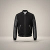 Scarlett Stitch Men's black bomber jacket with genuine leather sleeves, ribbed collar, cuffs, hem, and zippered pockets.