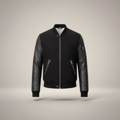 Scarlett Stitch Men's black bomber jacket with genuine leather sleeves, ribbed collar, cuffs, hem, and zippered pockets.