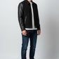 Scarlett Stitch Men's black wool bomber jacket with faux leather sleeves, zip front, and welt pockets.