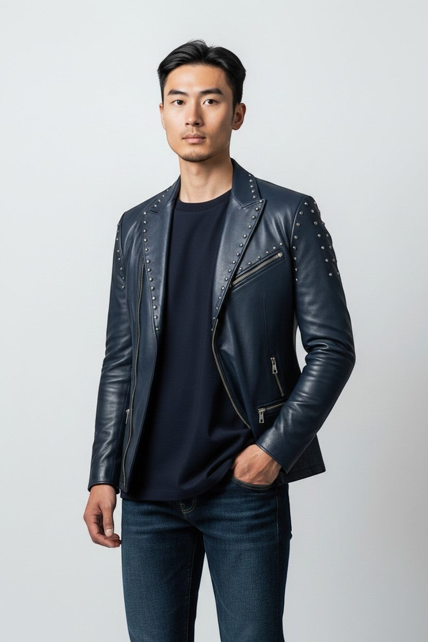 Scarlett Stitch Men's navy blue faux leather blazer jacket with silver stud accents on lapels and shoulders. Features zippered pockets and single-button closure.