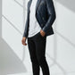 Scarlett Stitch men's navy blue faux leather blazer with silver stud accents on lapels and shoulders. Features zippered pockets and single-button closure.