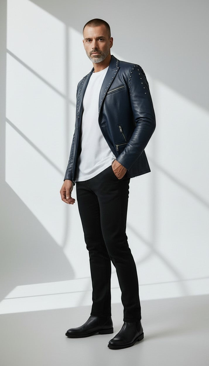 Scarlett Stitch men's navy blue faux leather blazer with silver stud accents on lapels and shoulders. Features zippered pockets and single-button closure.