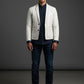Man wearing a Scarlett Stitch off-white leather blazer with a dark shirt and jeans against a grey studio background.