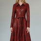 Scarlett Stitch red faux leather midi dress with distressed finish, pointed collar, button front, and tie waist.