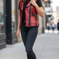 Scarlett Stitch women's red faux leather moto vest with black buckle accents and zip front. Fitted silhouette.