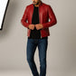 Scarlett Stitch men's red faux leather motorcycle jacket with stand-up collar and zippered pockets.