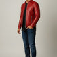Scarlett Stitch men's red faux leather motorcycle jacket with stand-up collar and zip pockets.
