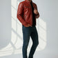 Model wearing a red Scarlett Stitch leather biker jacket with quilted shoulders, metal zippers, and cafe racer collar.
