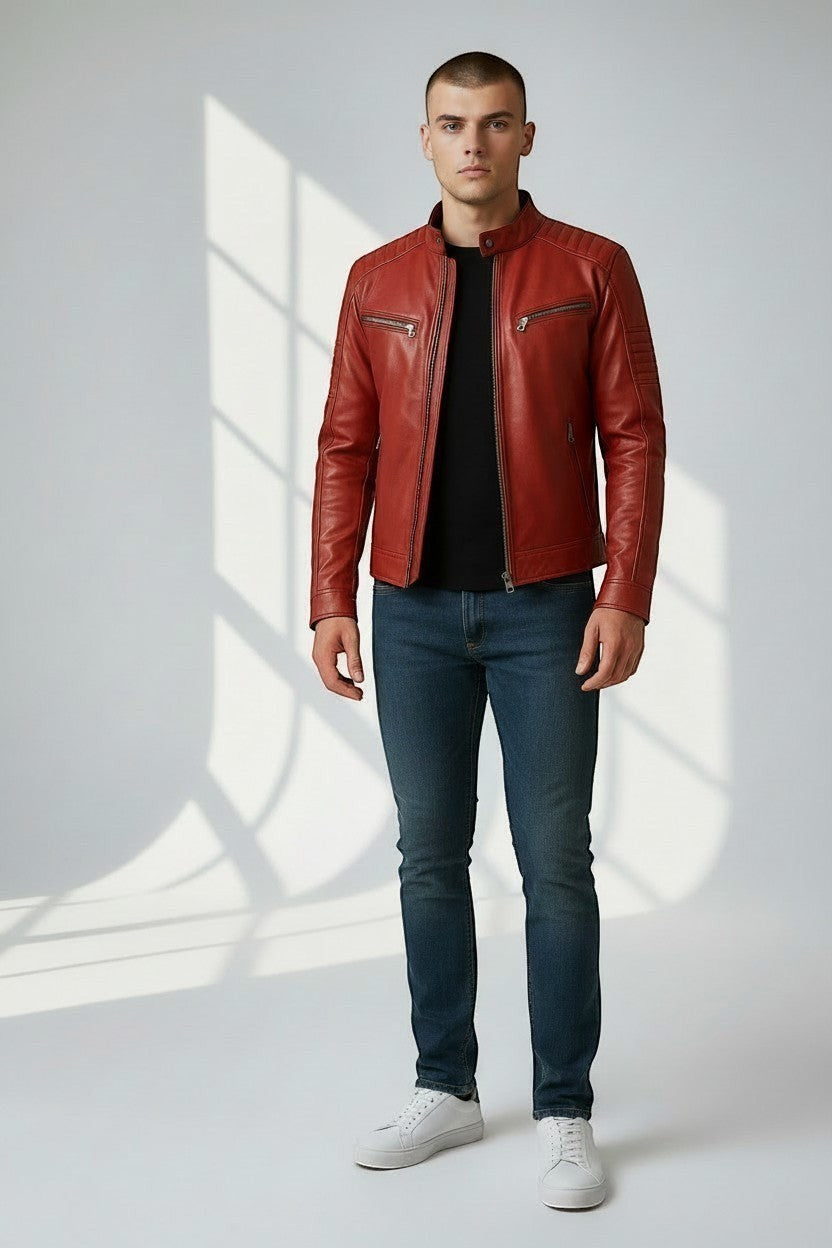 Model wearing a Scarlett Stitch red leather biker jacket with quilted shoulders and metal zippers over a black shirt.