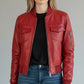 Scarlett Stitch red leather bomber jacket with zippered front, chest pockets, and sleeve pocket. Ribbed cuffs, collar, and hem.