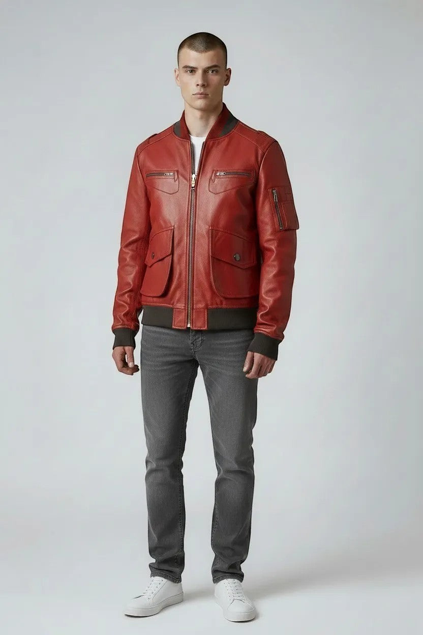 Scarlett Stitch men's red leather bomber jacket with ribbed collar, cuffs, and hem. Features zippered chest pockets and buttoned waist pockets.