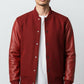 Scarlett Stitch red wool-blend varsity bomber jacket with genuine leather sleeves, snap-button front, and ribbed trim.