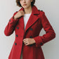 Scarlett Stitch red wool blend double-breasted peacoat with notched lapel, epaulets, and dark buttons.