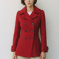 Scarlett Stitch red wool blend double-breasted peacoat with notched lapel and cuffed sleeves.