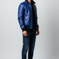 Scarlett Stitch royal blue leather bomber jacket with black ribbed collar, cuffs, and hem. Features flap pockets and epaulets.