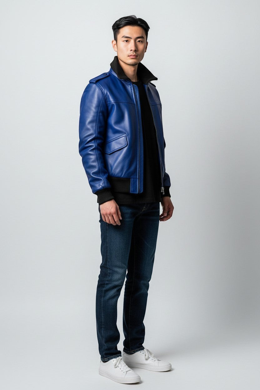 Scarlett Stitch royal blue leather bomber jacket with black ribbed collar, cuffs, and hem. Features flap pockets and epaulets.