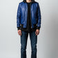 Scarlett Stitch royal blue leather bomber jacket with black ribbed collar, cuffs, and hem. Features zip front and flap pockets.