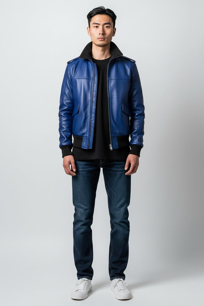 Scarlett Stitch royal blue leather bomber jacket with black ribbed collar, cuffs, and hem. Features zip front and flap pockets.