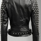 Scarlett Stitch black leather biker jacket with silver stud embellishments on sleeves and shoulders, belted waist.