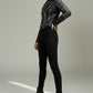 Model wearing a Scarlett Stitch black leather biker jacket with silver stud embellishments, zippers, and waist belt.
