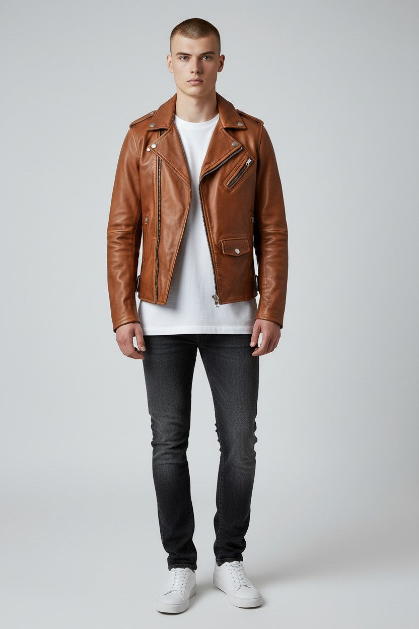 Model wearing a Scarlett Stitch tan leather biker jacket with asymmetrical zip, notched lapels, and waist belt.