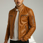 Scarlett Stitch tan leather cafe racer moto jacket with zippered pockets and snap collar worn by a man