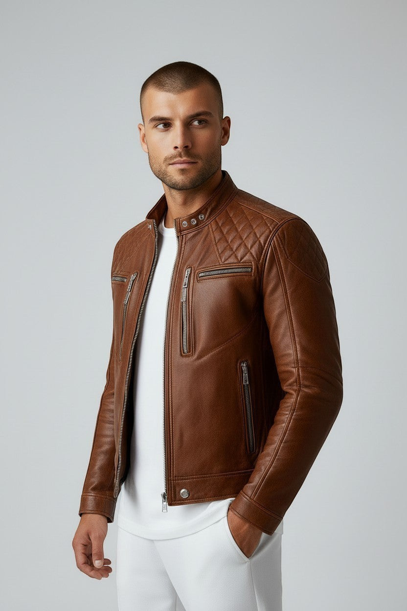 Scarlett Stitch men's tan leather biker jacket with quilted shoulders, mandarin collar, and silver-tone hardware.