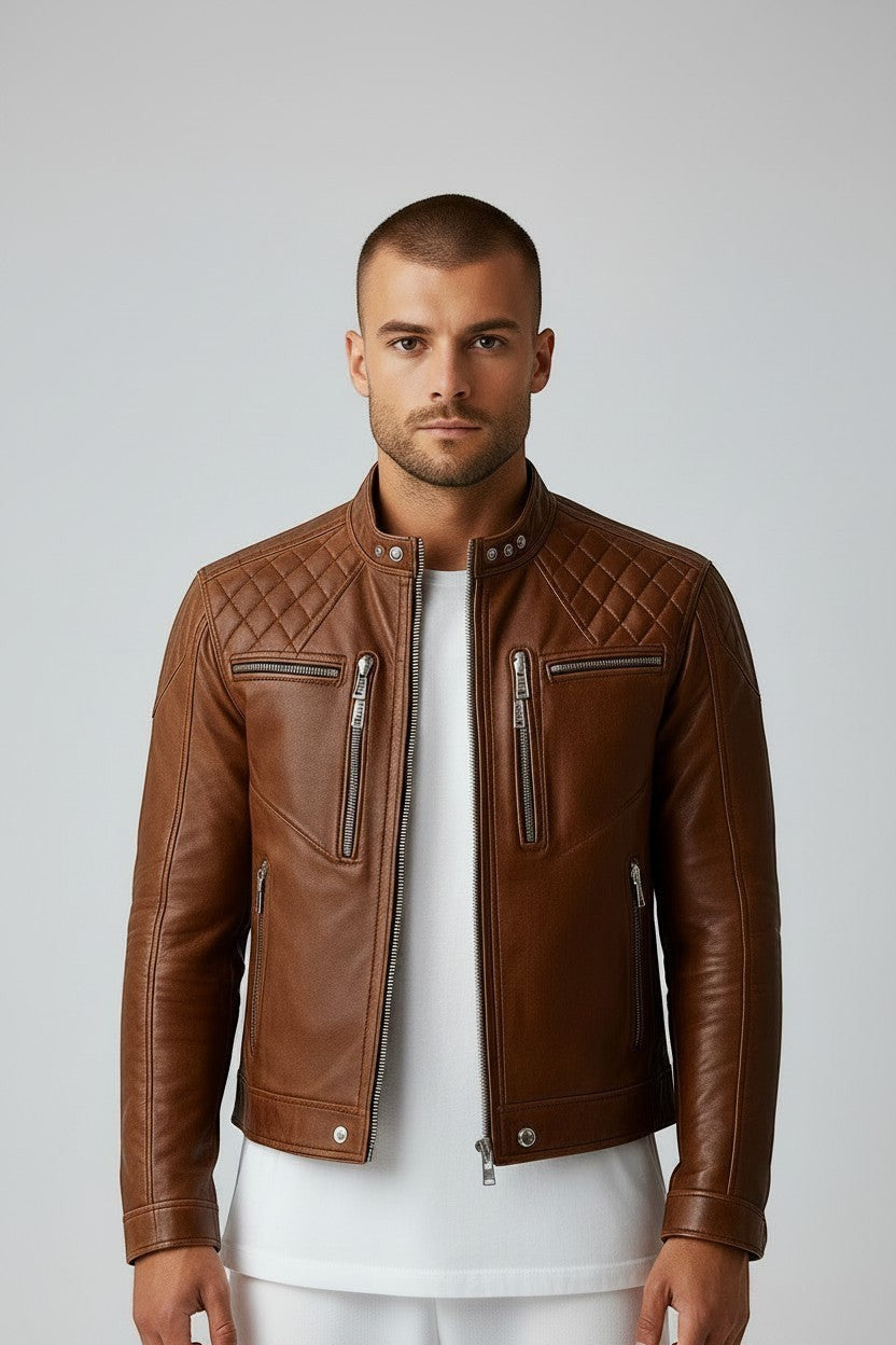 Scarlett Stitch men's tan leather biker jacket with quilted shoulders, mandarin collar, and silver-tone hardware.
