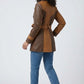 Scarlett Stitch women's two-tone brown leather belted trench coat with notched lapel and button cuffs.